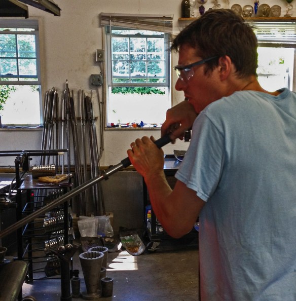 Glass Blower Gathering Molten Glass For A New Piece.