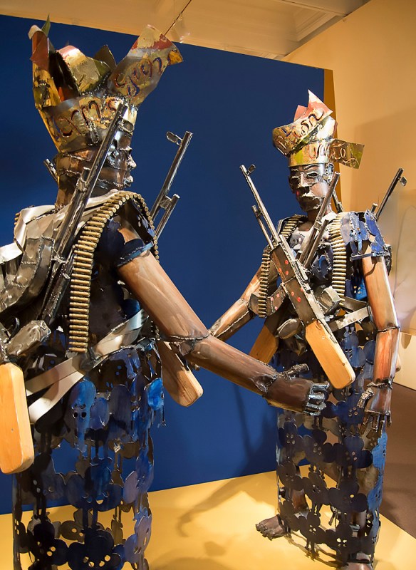Satirical sculpture, Two Nigerian Woman with AK-47s and Cartridges